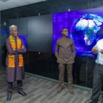 NCC's Executive Vice Chairman, Dr. Aminu Maida listens to an official of Ghana's National Communications Authority